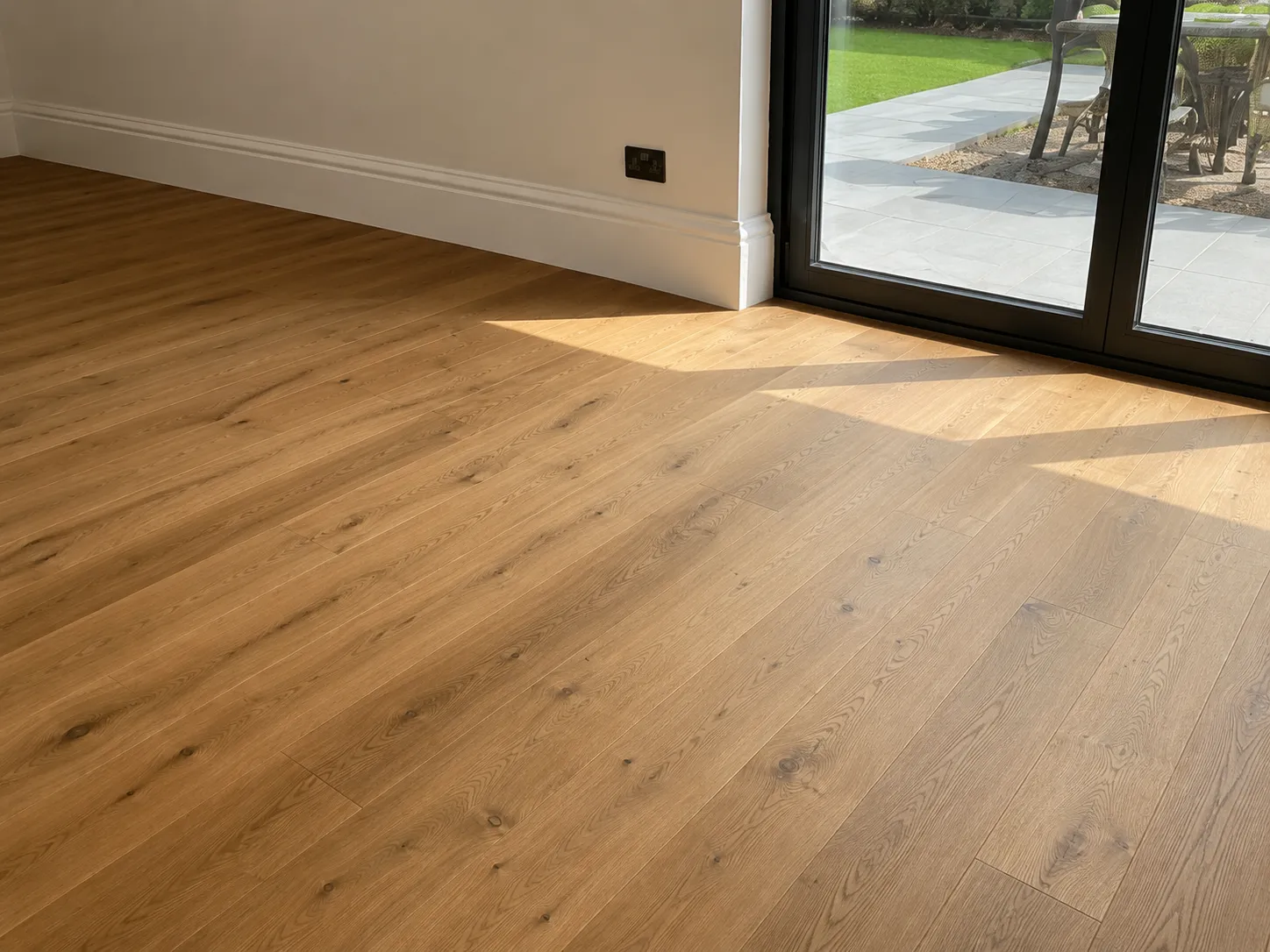 Engineered oak flooring laid through a living room and hallway